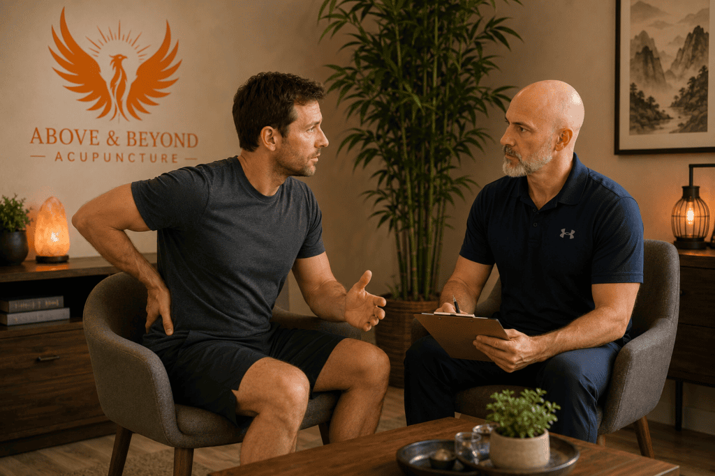 Acupuncturist discussing persistent lower-back pain with a patient during a clinical consultation.