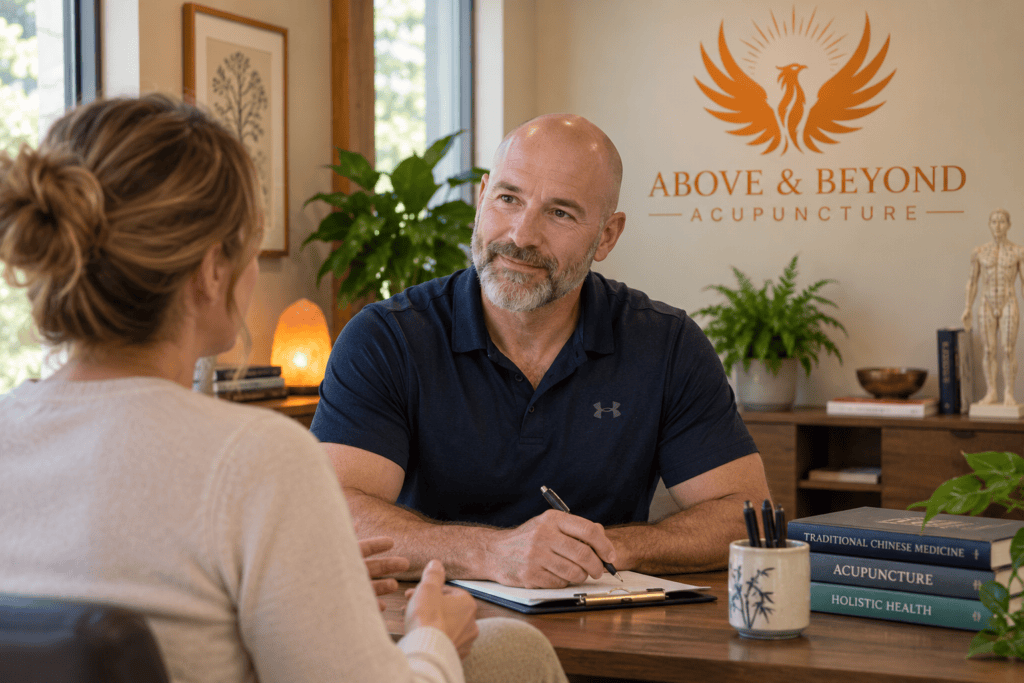 Acupuncturist listening attentively to a patient during a calm consultation about immune health.