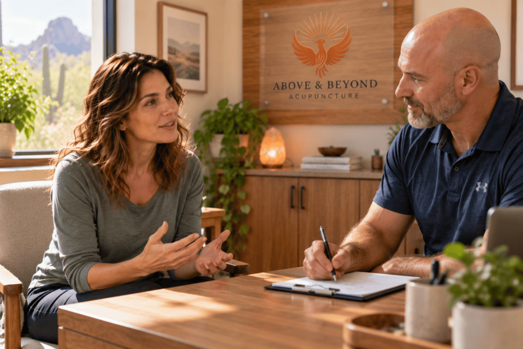 Woman discussing her symptoms and acupuncture treatment plan with her acupuncturist.