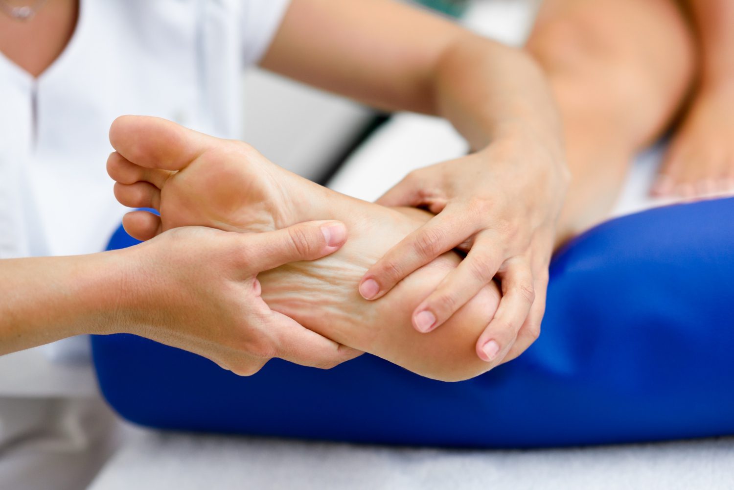 Practitioner examining a patient's foot prior to peripheral neuropathy treatment at a Scottsdale acupuncture clinic.