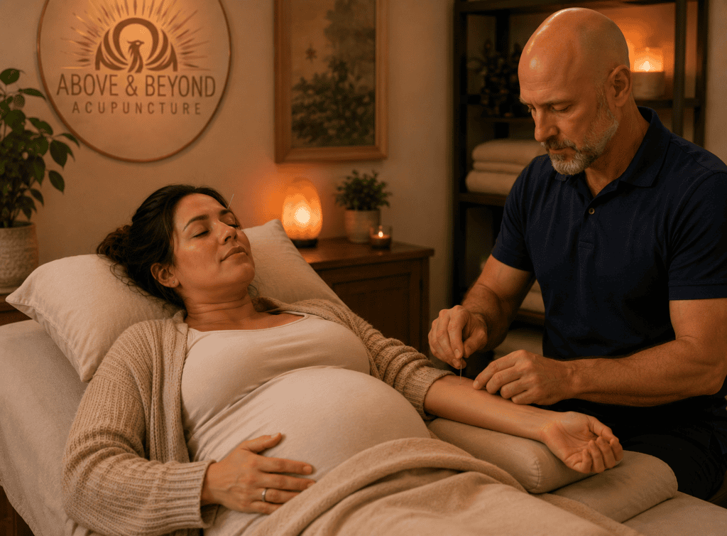 Pregnant woman resting comfortably on a treatment table during a calm acupuncture session for morning sickness.
