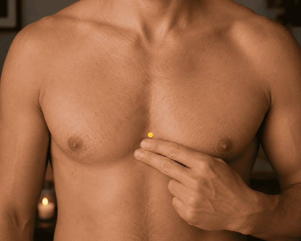 Close-up of the center of the chest with a yellow dot marker on the breastbone at nipple level, indicating CV17.