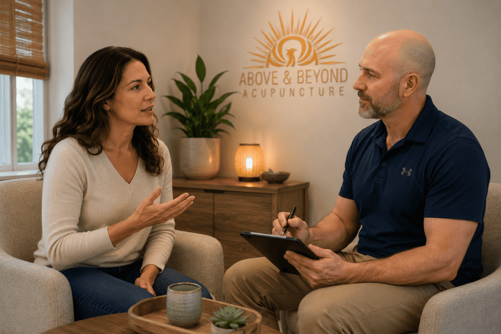 Acupuncturist having an in-depth holistic intake conversation with a patient at Above and Beyond Acupuncture.