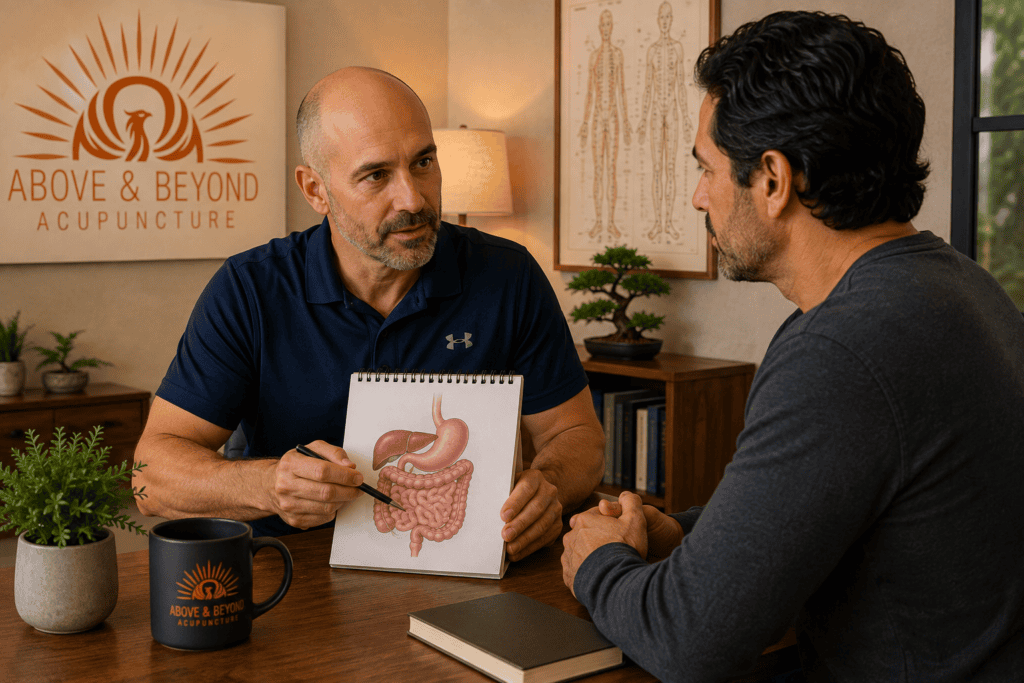Acupuncturist discussing digestive symptoms with a patient during a calm consultation.