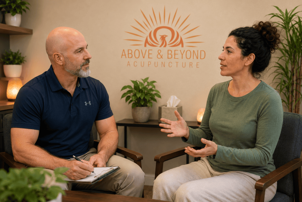 Woman discussing her symptoms with a licensed acupuncturist during a follow-up consultation at Above and Beyond Acupuncture.
